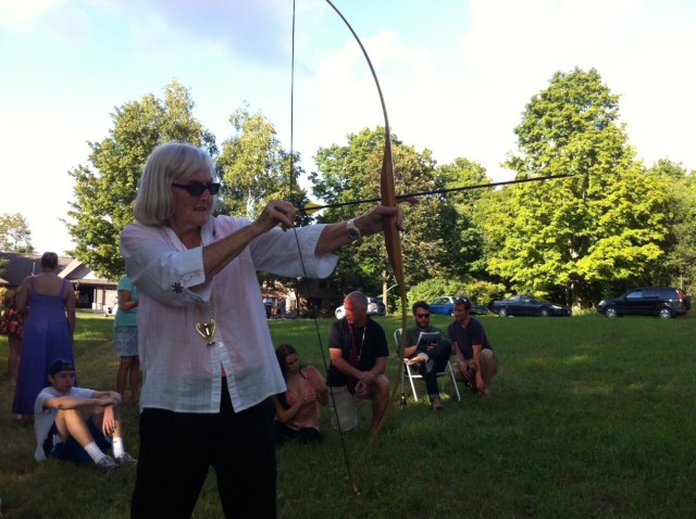 Audrey shooting a bow and arrow