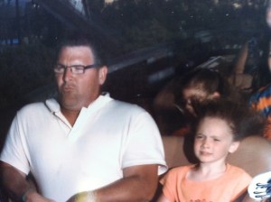 Father and daughter riding rollercoaster
