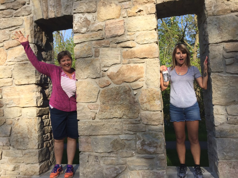 women standing in ruins