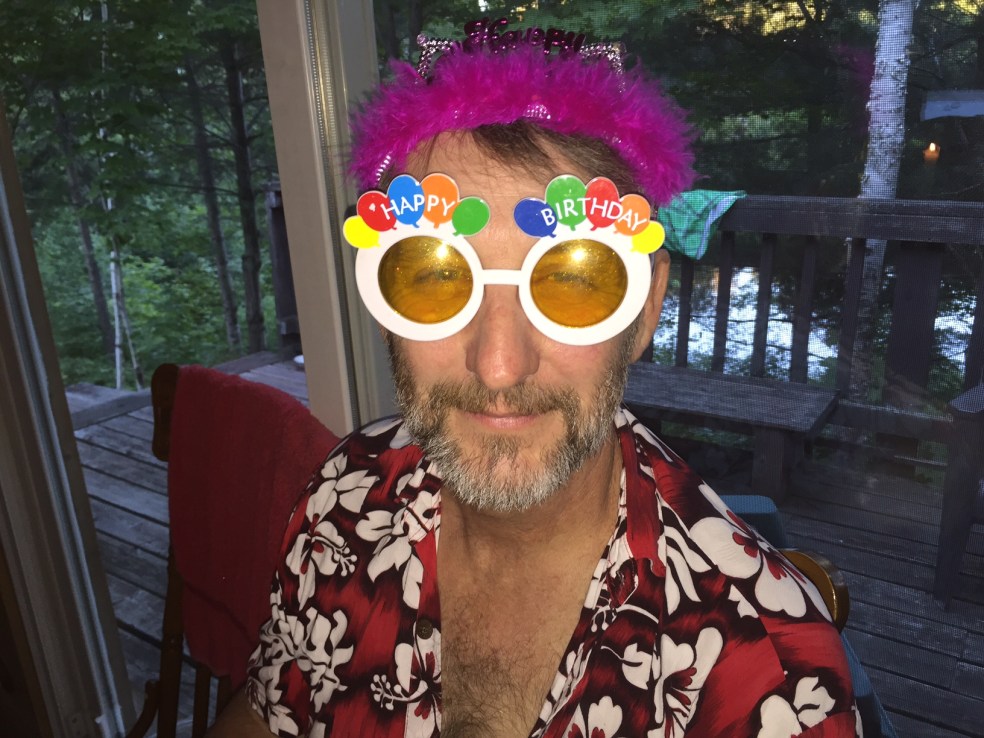 Man with birthday hat and glasses