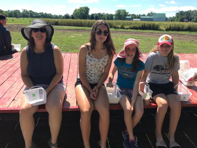 family sitting on a wagon