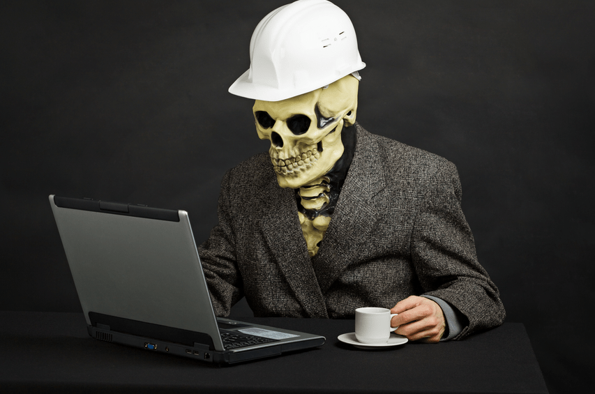 skeleton looking at a computer