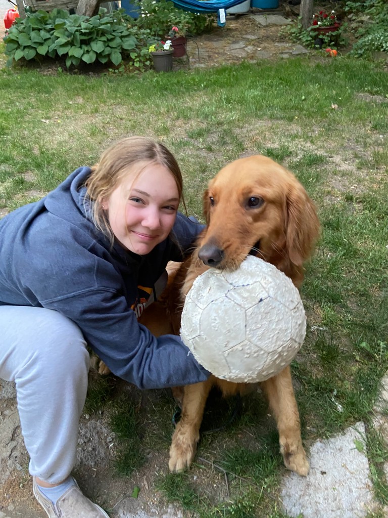 Girl with dog and ball