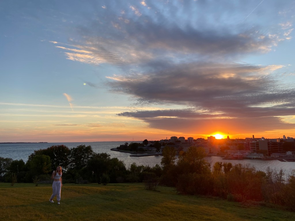 Clare on Fort Henry hill as the sun sets over Kingston