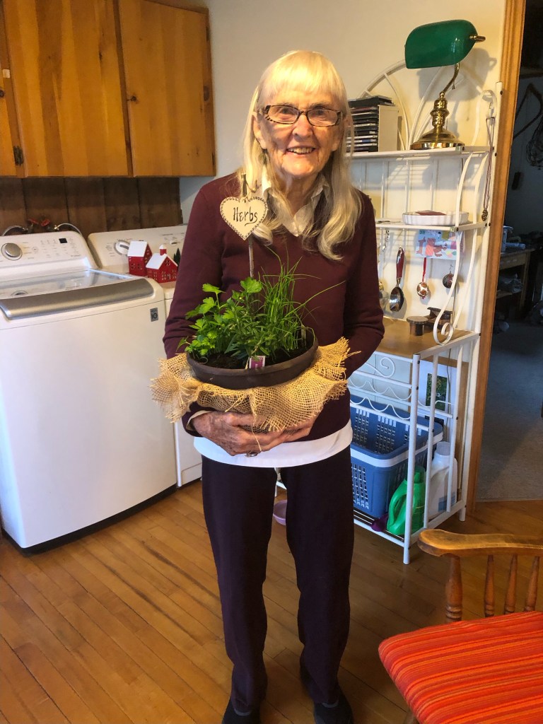 Woman holding a basket of herbs