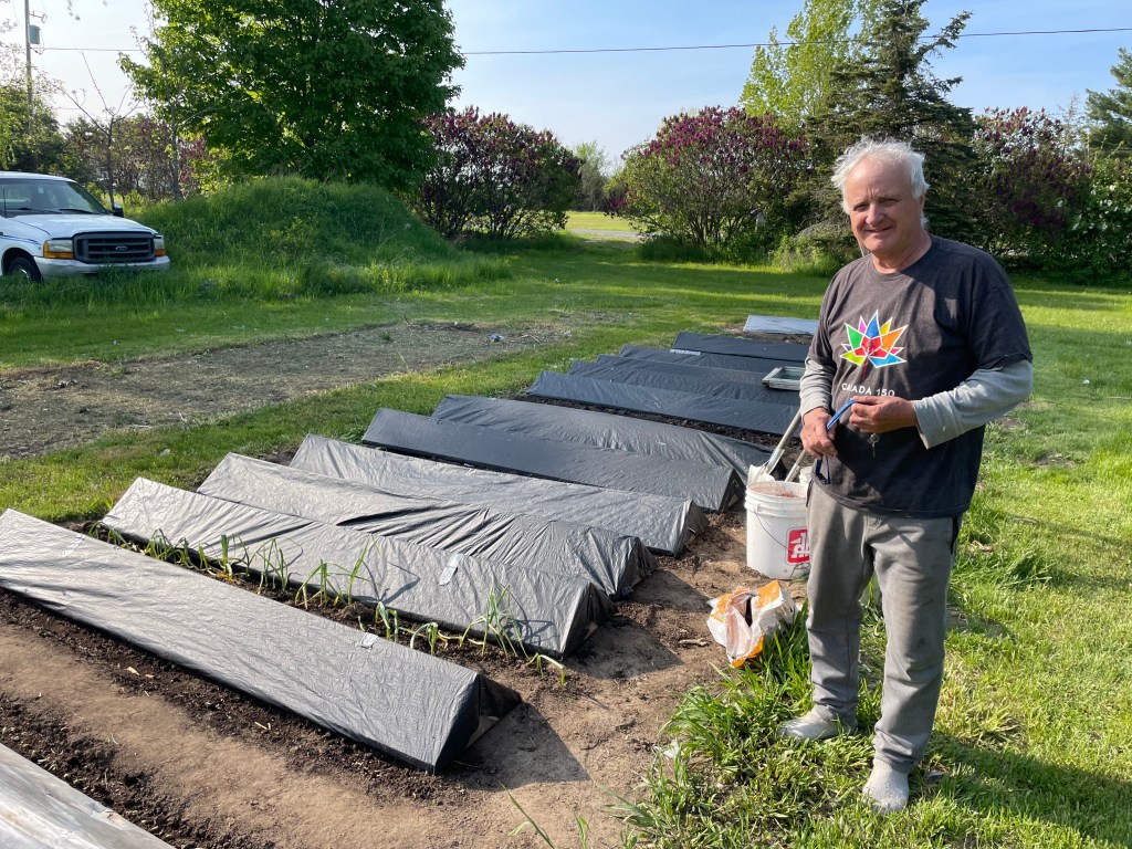 Man in front of a garden