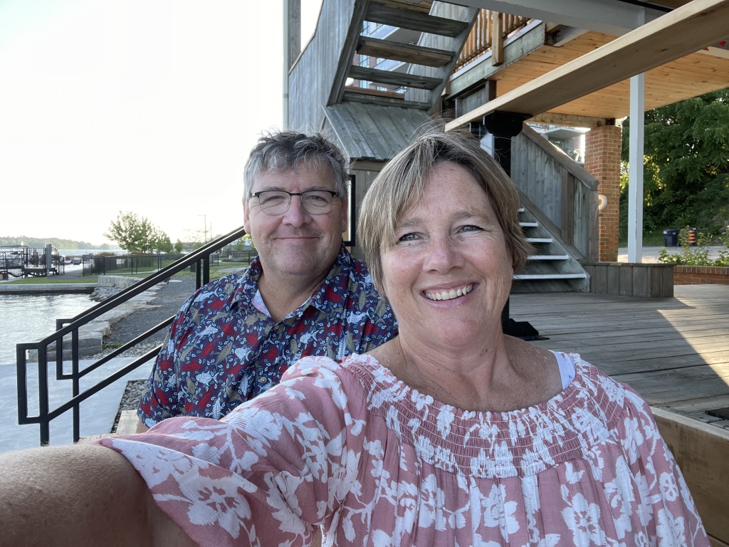 author and her husband on the benches at the playhouse