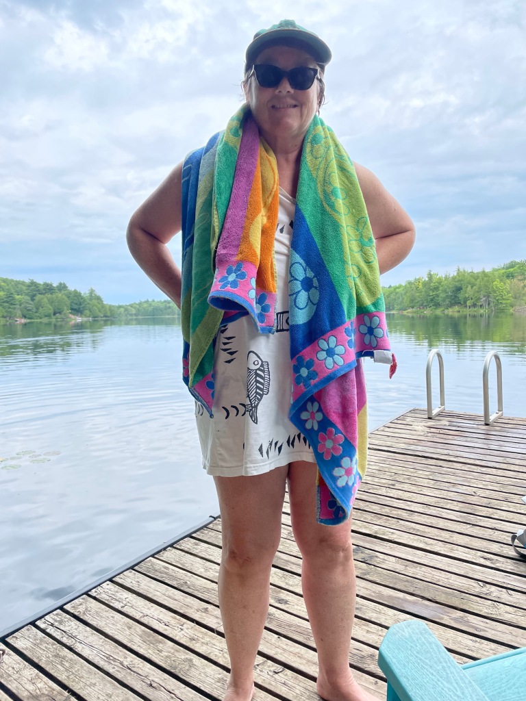 Author at the lake with a towel draped around her neck