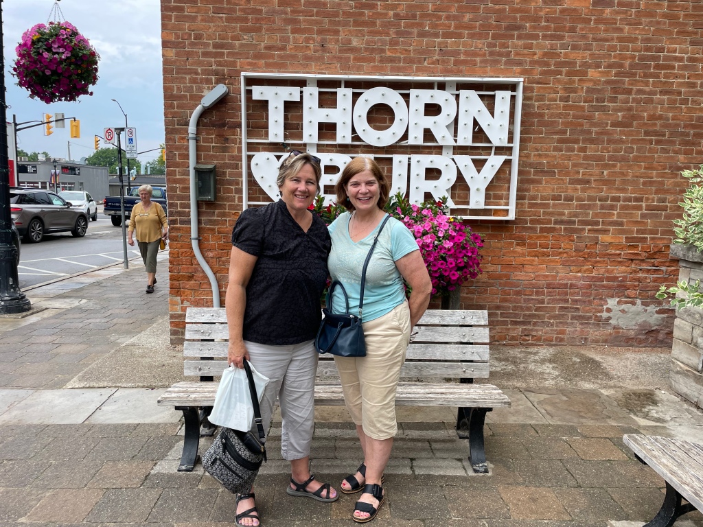 Me and my friend Barbara in front of the Thornbury sign