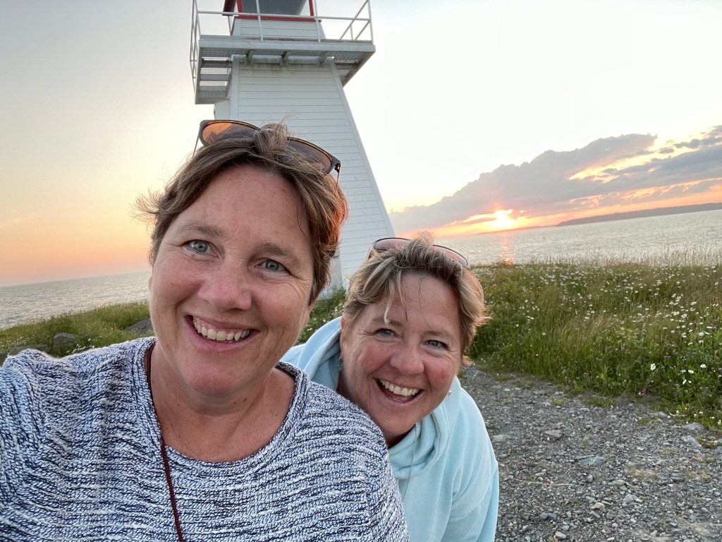 Author and friend in front of a lighthouse