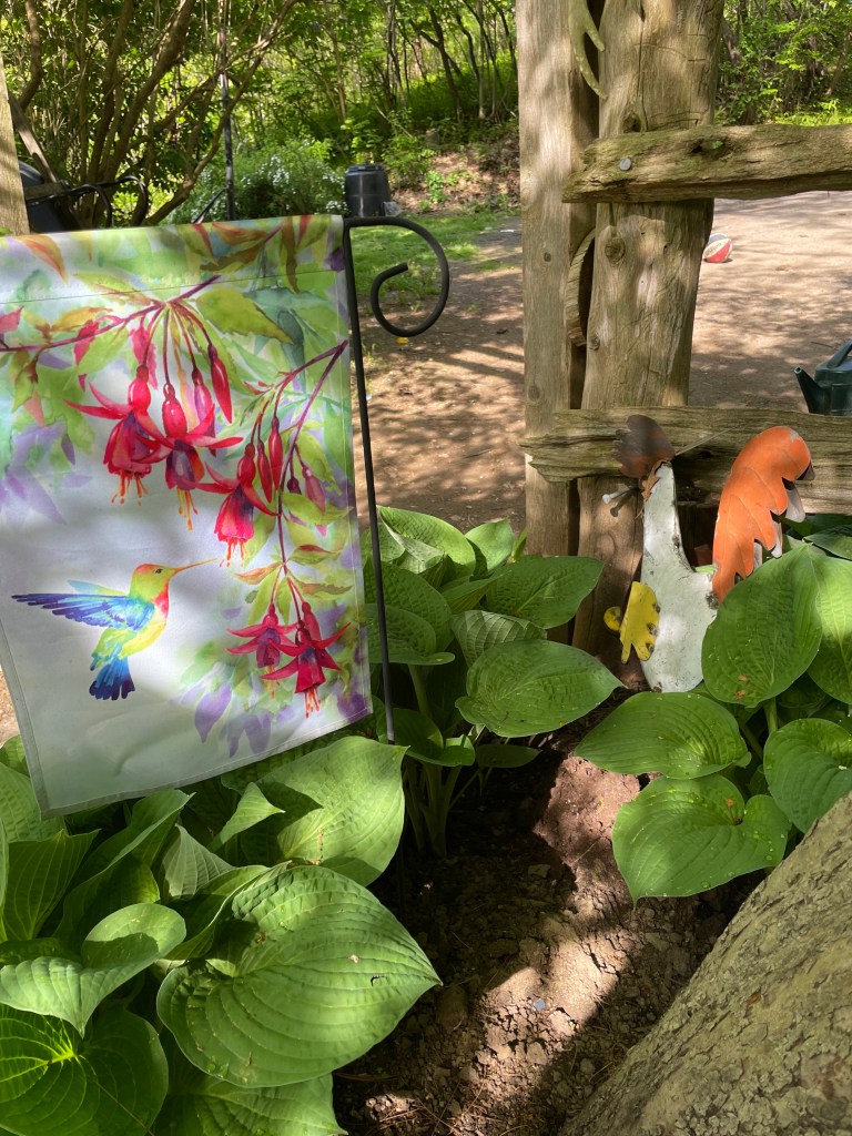 garden flag and chicken sculpture