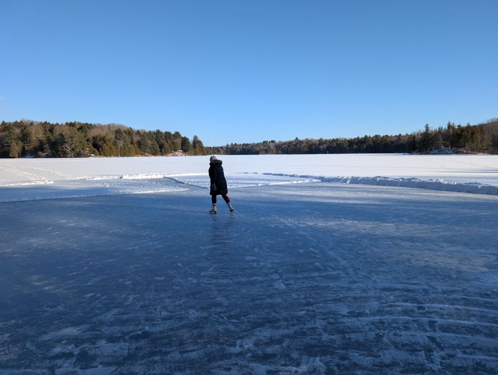 Woman skating on a frozen lake