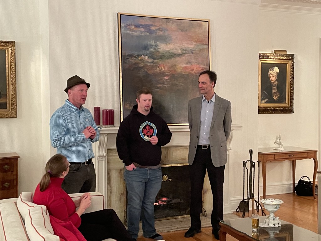 men standing in front of a fireplace