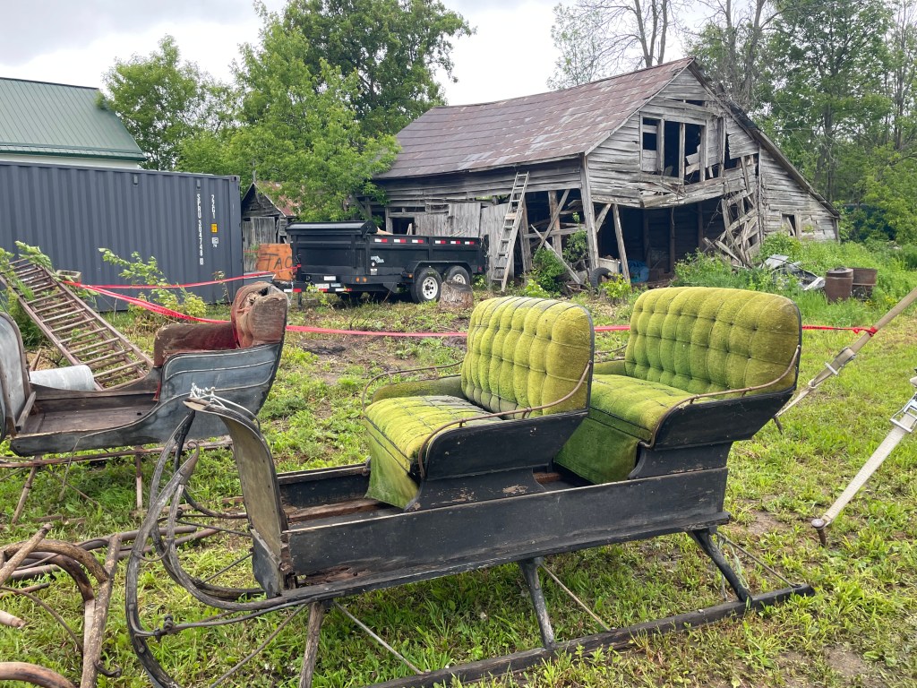 Antique sleigh in front of a barn