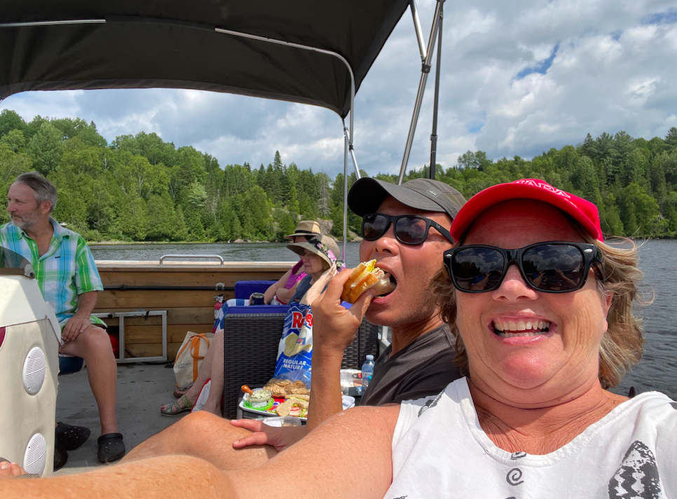 Man and woman eating chips on a pontoon boat