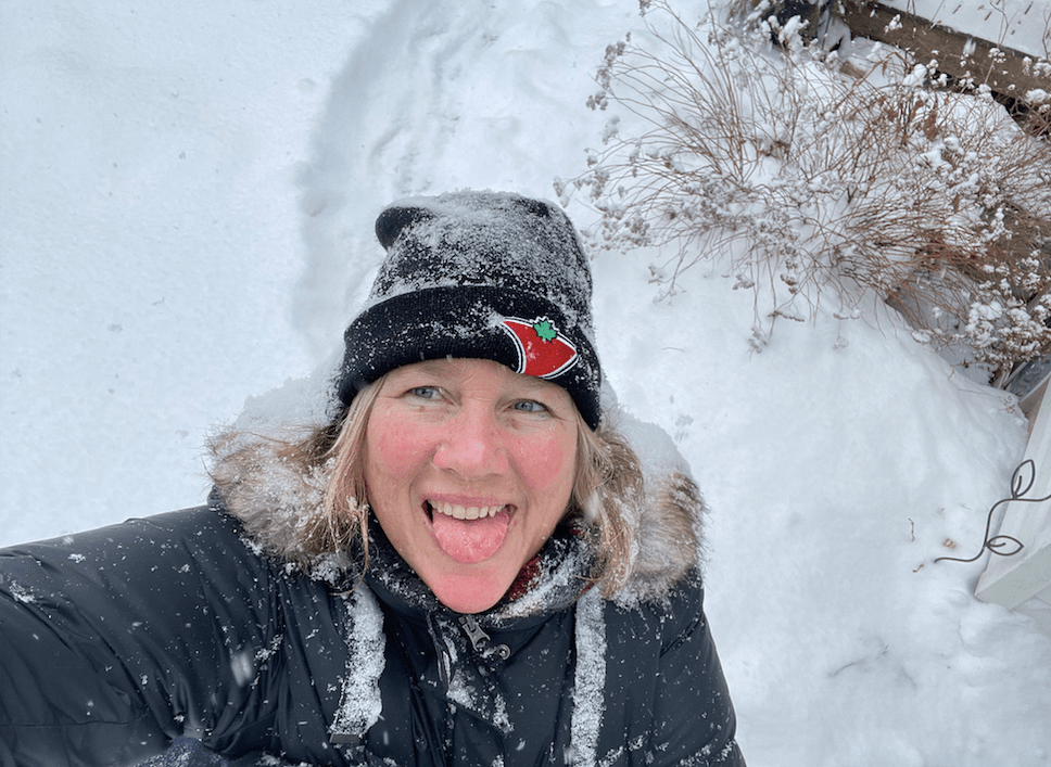 Woman catching snowflakes
