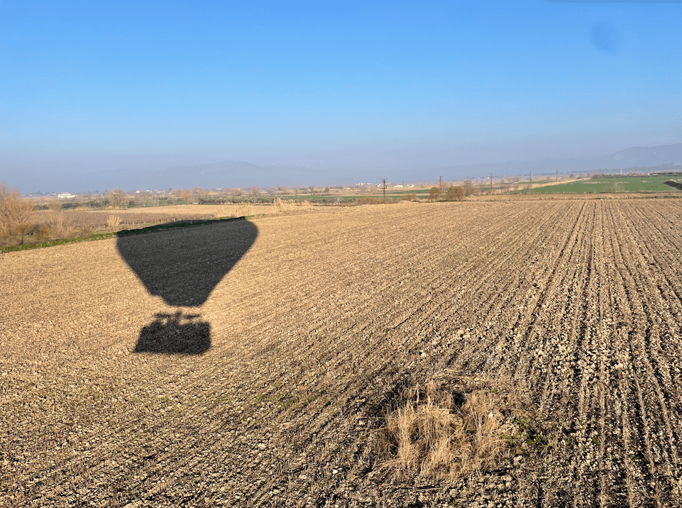 Shadow of hot air balloon over the fields of Turkey