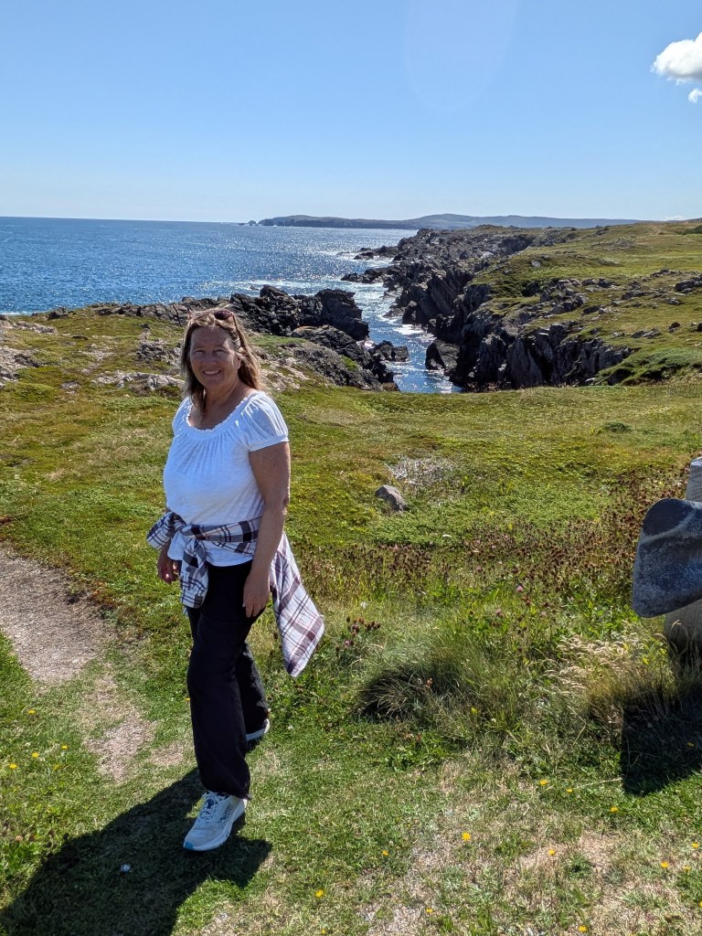 Woman standing on a rocky shore
