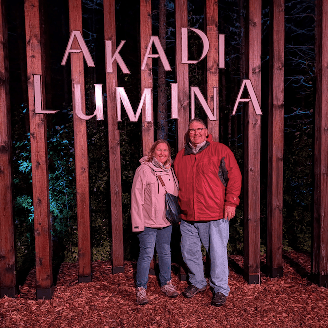 Couple standing in front of Akadi Lumina sign