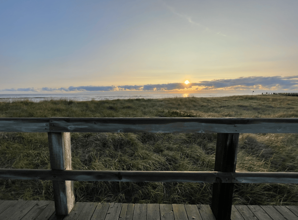 boardwalk by the ocean at sunrise